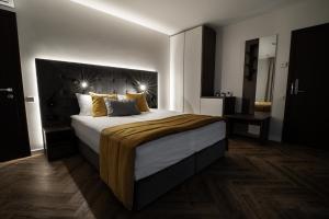 Postel nebo postele na pokoji v ubytování Jono kalnelis Apartments