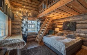 a bedroom in a log cabin with a bed and a ladder at Wilderness Hotel Nellim & Igloos in Nellimö
