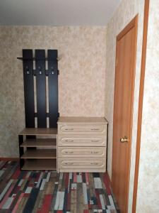 a room with a dresser and a closet with a door at Заветы Ильича in Vityazevo