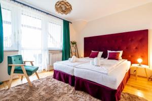 a bedroom with a large bed and a large window at Zacisze Zielone Ogrody in Mońki