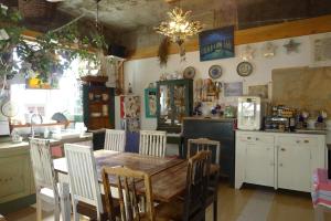 a kitchen with a wooden table and chairs in it at The House Hostel in Sokcho