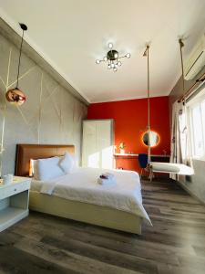 a bedroom with a white bed and white walls at Dylan Hotel in Vung Tau