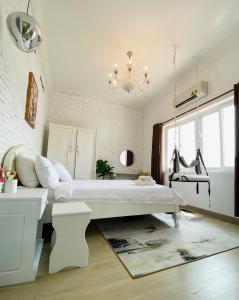 a living room filled with furniture and a window at Dylan Hotel in Vung Tau