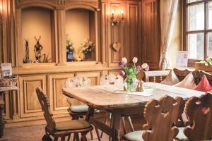 a dining room with a wooden table and chairs at Hotel Schartner in Altenmarkt im Pongau