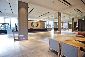 a lobby of a building with tables and chairs at The Suites Taitung in Taitung City