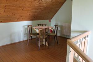 a room with a table and chairs on a balcony at Chata pod lesom Nová Baňa in Nová Baňa
