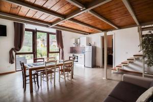a kitchen and dining room with a table and chairs at Agriturismo Monteroseo in bedizzol