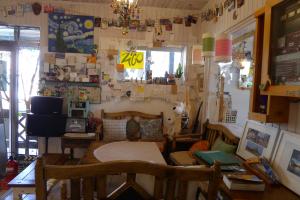 a living room with a table and chairs and a desk at The House Hostel in Sokcho