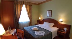 Postel nebo postele na pokoji v ubytování Hotel Squarciarelli