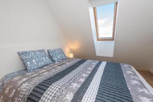 a bedroom with a bed with blue pillows and a window at Rainbow Palanga in Palanga +11 photos