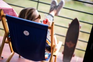 a young girl sitting in a chair with her feet up at Aparthotel Flinski Sport & SPA in Świeradów-Zdrój