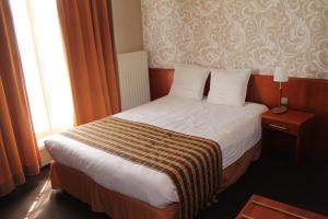 Postel nebo postele na pokoji v ubytování Hotel De Notelaer