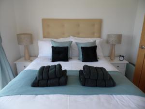 a bedroom with a bed with two pillows on it at Seaside Apartment in Carbis Bay
