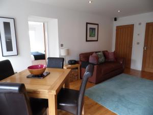 a living room with a table and a couch at Seaside Apartment in Carbis Bay