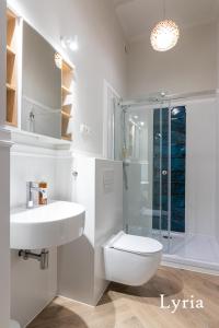 a bathroom with a sink and a toilet and a shower at Brokilon House in Kraków