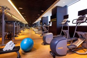 a gym with a bunch of treadmills and exercise equipment at Crowne Plaza Kunshan, an IHG Hotel in Kunshan