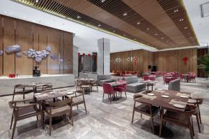 a restaurant with wooden walls and tables and chairs at Crowne Plaza Kunshan, an IHG Hotel in Kunshan