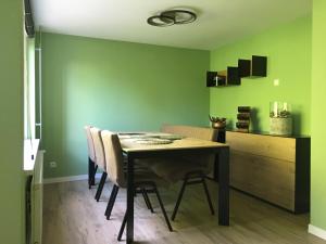 a dining room with a table and some green walls at Appartement Buiten de Veste 28 in Veere