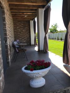 a patio with a vase with flowers in it at вулиця 8-го Березня Апартаменты in Myrhorod