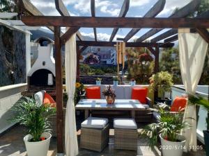 un patio con pérgola de madera, mesa y sillas en Apartamentos El Patio en Los Llanos de Aridane