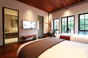 Ένα ή περισσότερα κρεβάτια σε δωμάτιο στο Mogan Mountain Fangu Boutique Villa