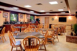 a restaurant with tables and chairs and a bar at Best Western Mason Inn in Mason