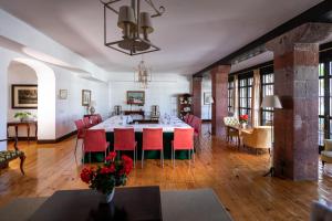 a dining room with a table and red chairs at Parador de La Gomera in San Sebastián de la Gomera