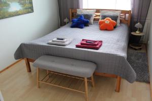 a bed with stuffed animals sitting on top of it at City centre apartment Siilinjärvi in Siilinjärvi