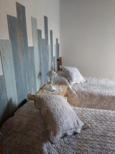 a bedroom with two beds and a teddy bear on the floor at Casa da Souropires in Pinhel