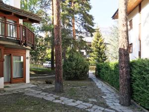 a group of trees in front of a house at Scoiattolo in Bardonecchia