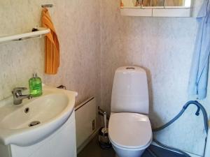a small bathroom with a toilet and a sink at 4 person holiday home in Glesborg in Glesborg