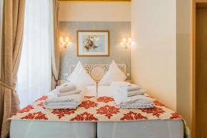 a bedroom with a bed with white pillows on it at Arbio I Parlamento Rooms near Schonhauser Allee in Berlin