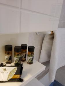 a shelf with three jars of spices on it in a bathroom at Nefeli in Livadi
