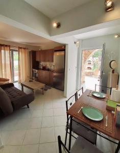 a kitchen and living room with a table and a couch at Nefeli in Livadi