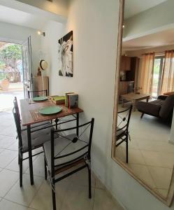 a table and chairs in a room with a mirror at Nefeli in Livadi