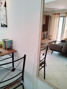 a mirror on a wall in a living room at Nefeli in Livadi