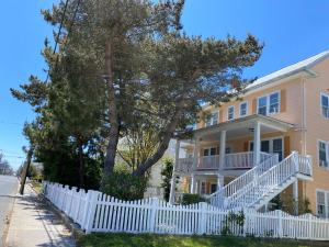 a white picket fence in front of a house at Nock Apartments in Ocean City