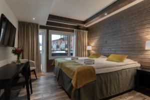 Ένα ή περισσότερα κρεβάτια σε δωμάτιο στο Ski-Inn RukaValley