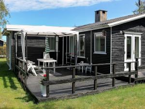 Casa con terraza con mesa y sillas en 6 person holiday home in Storvorde, en Storvorde