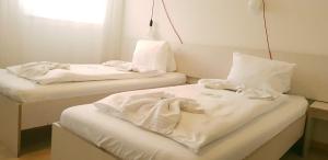 
Ein Bett oder Betten in einem Zimmer der Unterkunft Easy-Living Budget Rooms Lindenstrasse 48
