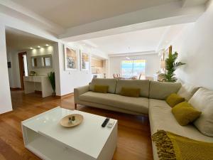 a living room with a couch and a table at Home Out Luxury Marina Apartment - 2 Bedrooms Sea View in Vilamoura