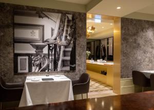 a dining room with a table and a mirror at Vila Foz Hotel & SPA - member of Design Hotels in Porto