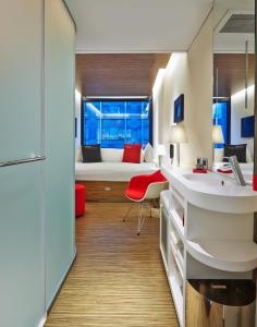 a room with a bedroom with a bed and a desk at citizenM New York Times Square in New York