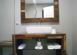 a bathroom with a sink and a mirror and towels at Karem Bay in Kumak