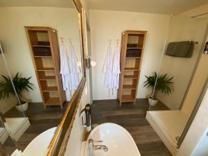 a bathroom with a shower and a sink and a mirror at Alpinhotel INzeller in Inzell