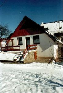 a house with snow on the ground in front of it at Ferienwohnung Teubner in Bockau