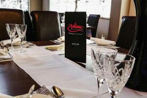 a table with wine glasses on top of it at Ashiana in Newark-on-Trent