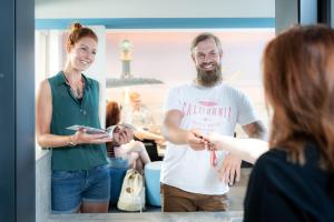 a man and a woman standing in a room at WIROtel Warnemünde in Warnemünde