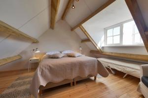 En eller flere senge i et værelse på Gastenverblijven boerderij Het Driespan