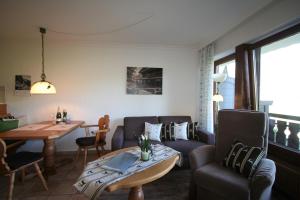 a living room with a couch and a table at Alpenflair Ferienwohnungen Whg 205 in Oberstdorf